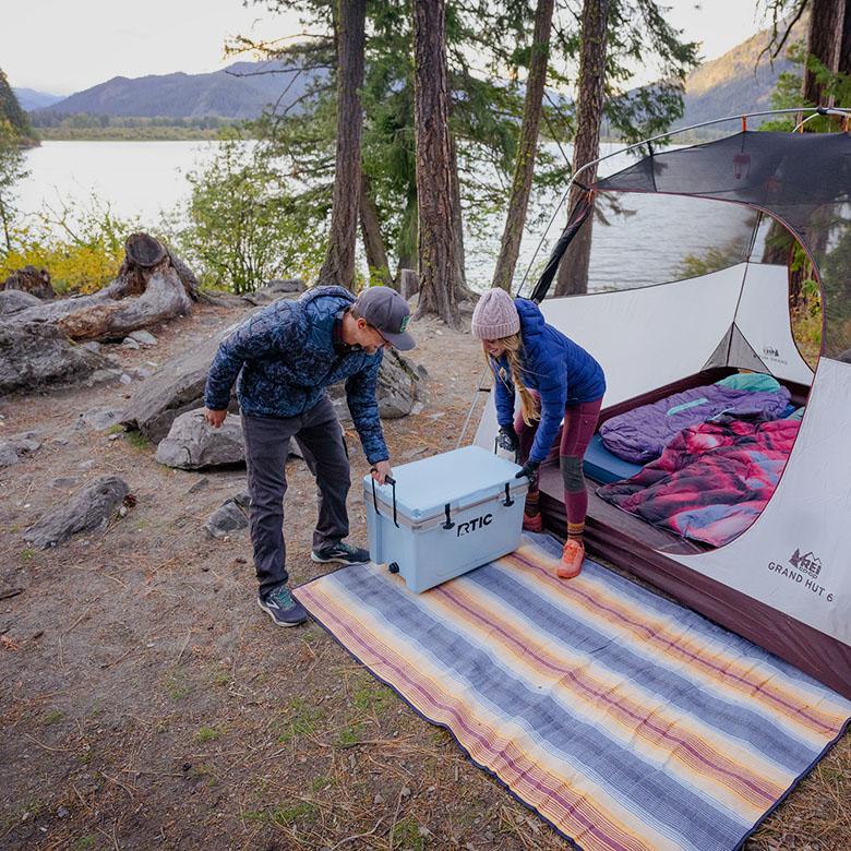 Camping gear (putting cooler down at camp)