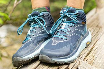 Hoka One One Toa (standing on log)