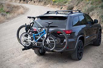 Kuat Transfer V2 hitch bike rack (two bikes behind Jeep)