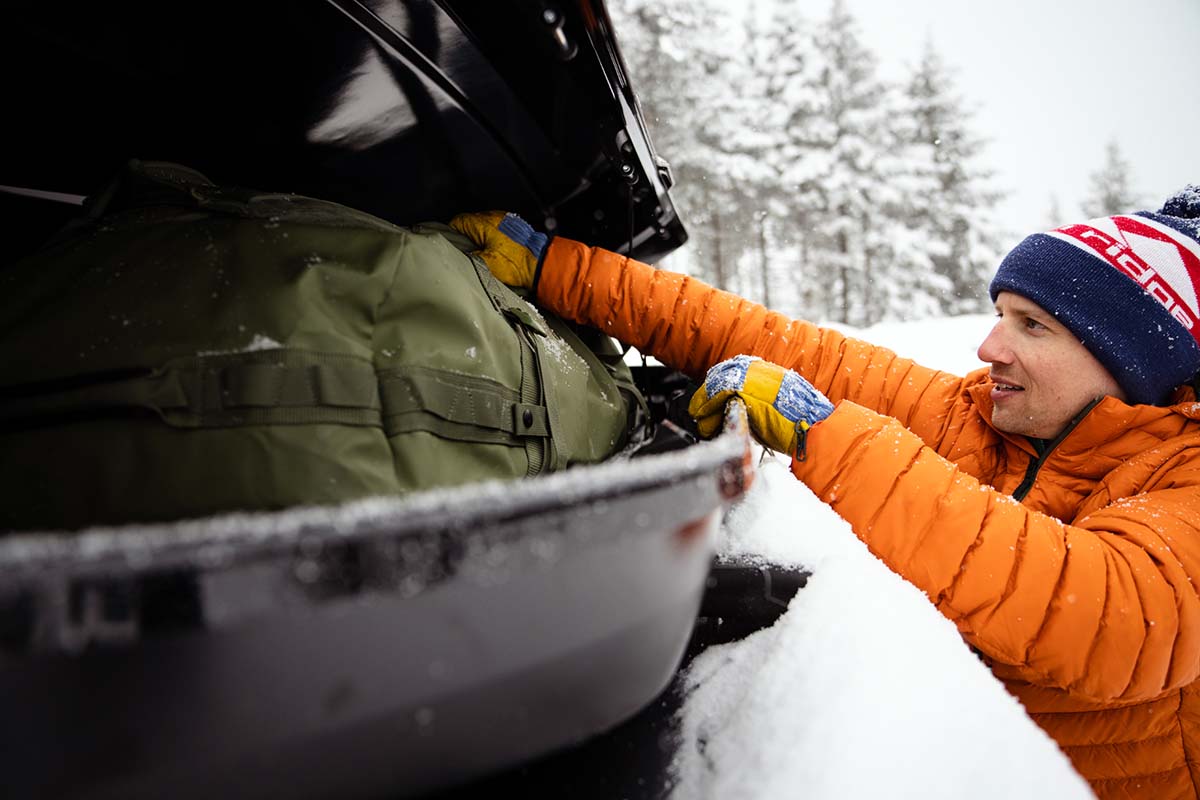 Loading duffell into rooftop cargo box