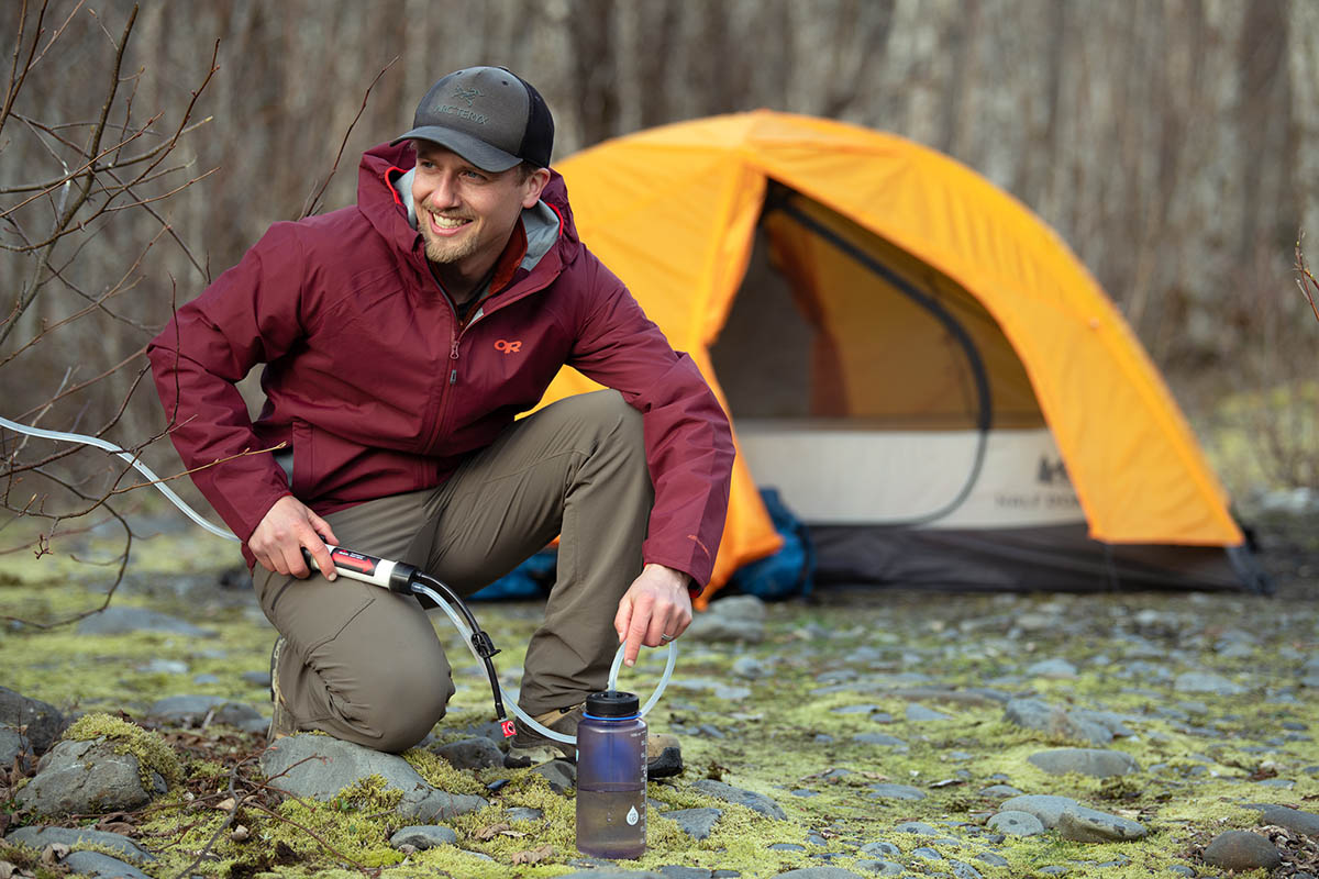 Rain jacket (Outdoor Research Motive filtering water at camp)