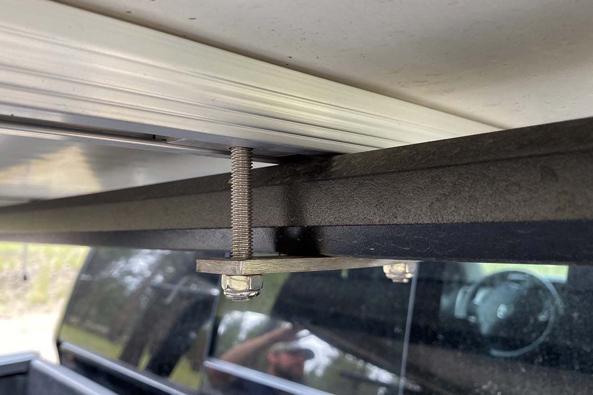 Rooftop tent attachment to roof rack